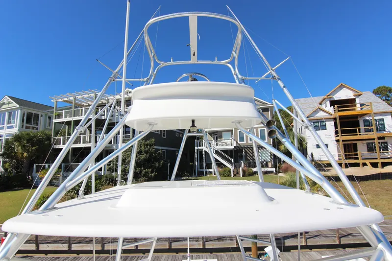 Slide: The Image of 2008 Bertram 360 yacht with tower against a clear blue sky and waterfront homes. - 15