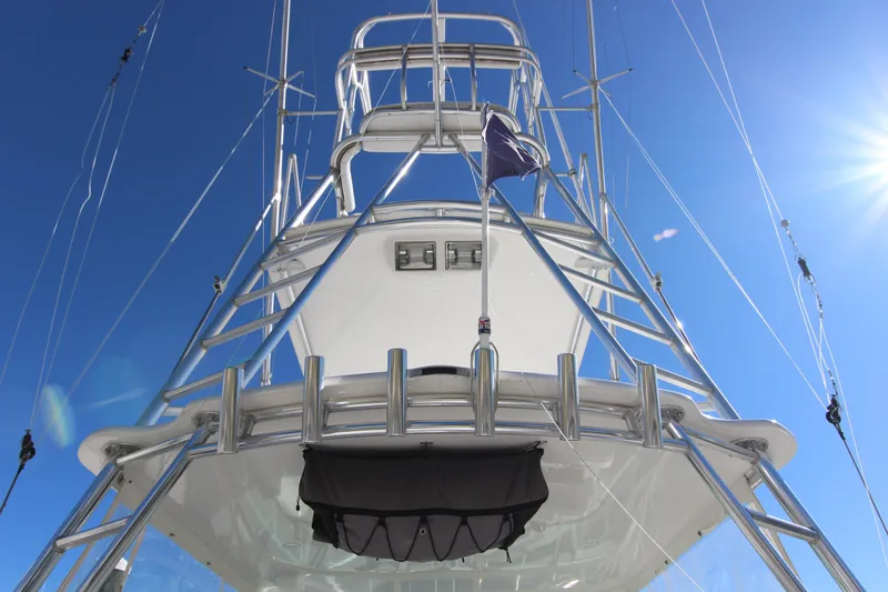 Slide: The Image of 2008 Bertram 360 yacht tower against clear blue sky, showcasing sleek design and structure. - 24