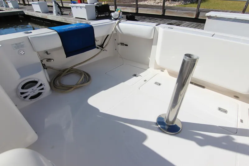 Slide: The Image of 2008 Bertram 360 boat deck with fishing rod holder and storage compartments. - 25