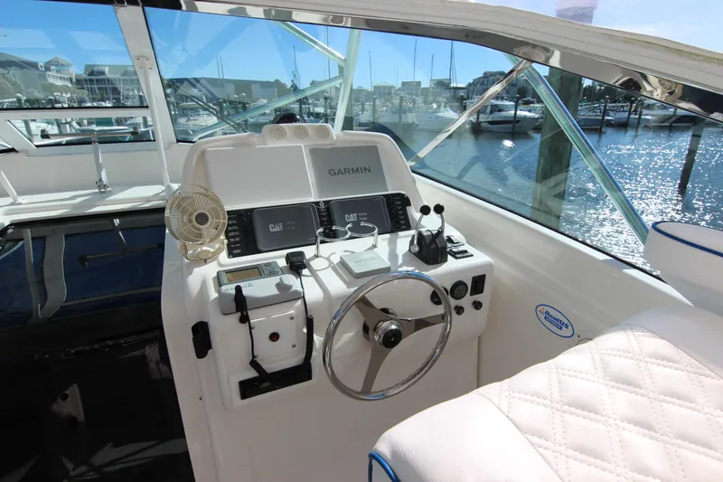 Slide: The Image of Cockpit of 2008 Bertram 360 yacht with Garmin navigation system and marina view. - 31