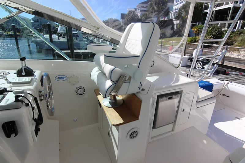 Slide: The Image of 2008 Bertram 360 yacht cockpit with helm seat and control panel, docked at marina. - 33