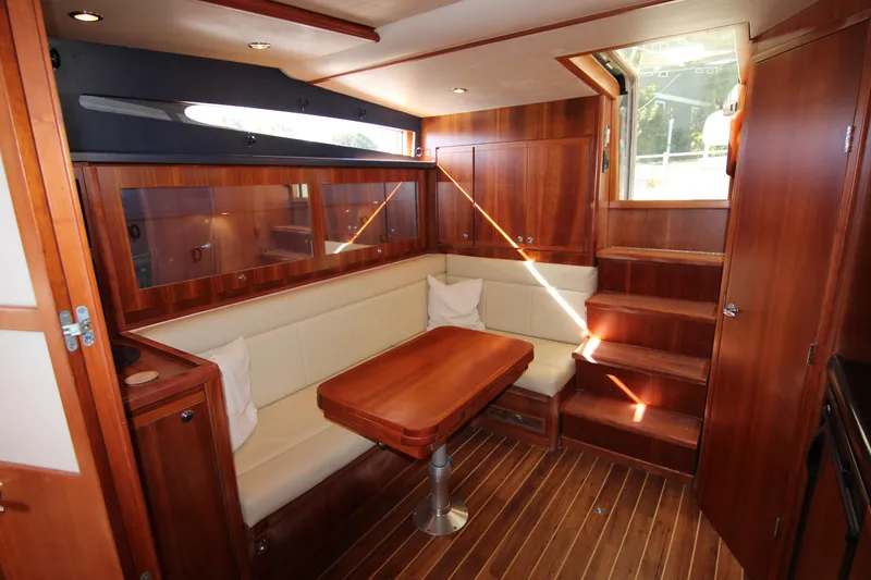 Slide: The Image of Luxurious interior of 2008 Bertram 360 yacht with wooden finishes and cozy seating area. - 38