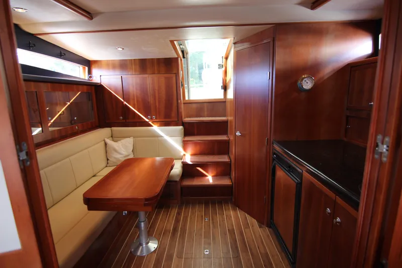 Slide: The Image of Luxurious 2008 Bertram 360 yacht interior with wood finish and cozy seating area. - 39