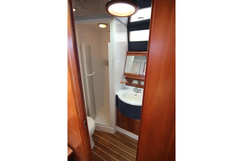 Slide: The Image of 2008 Bertram 360 yacht bathroom with wooden accents and modern fixtures. - 41