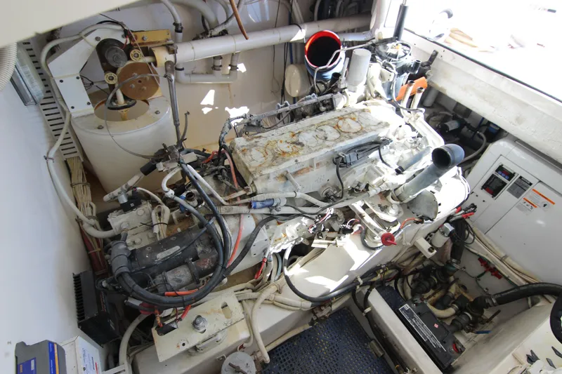 Slide: The Image of Engine room of a 2008 Bertram 360 boat, showcasing mechanical components and wiring. - 53