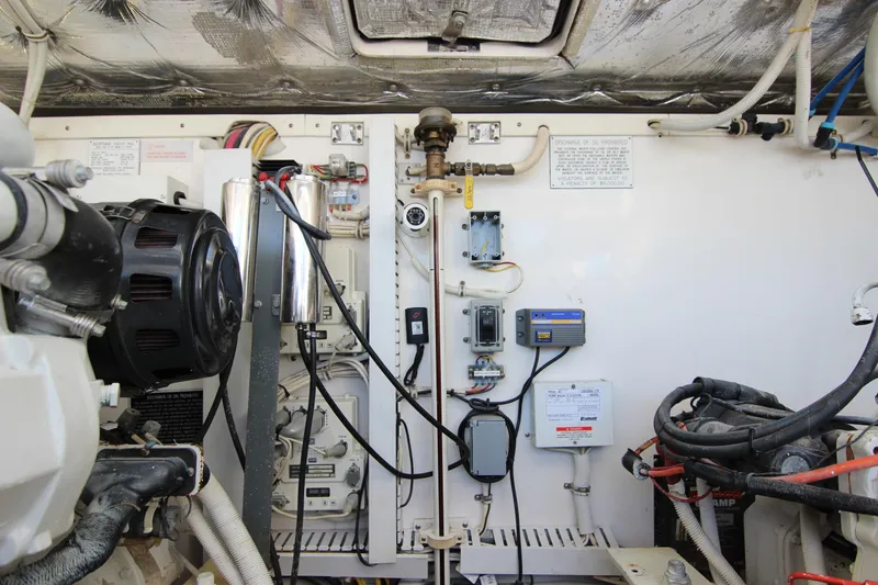 Slide: The Image of Engine room of a 2008 Bertram 360 boat, showcasing wiring and mechanical components. - 54