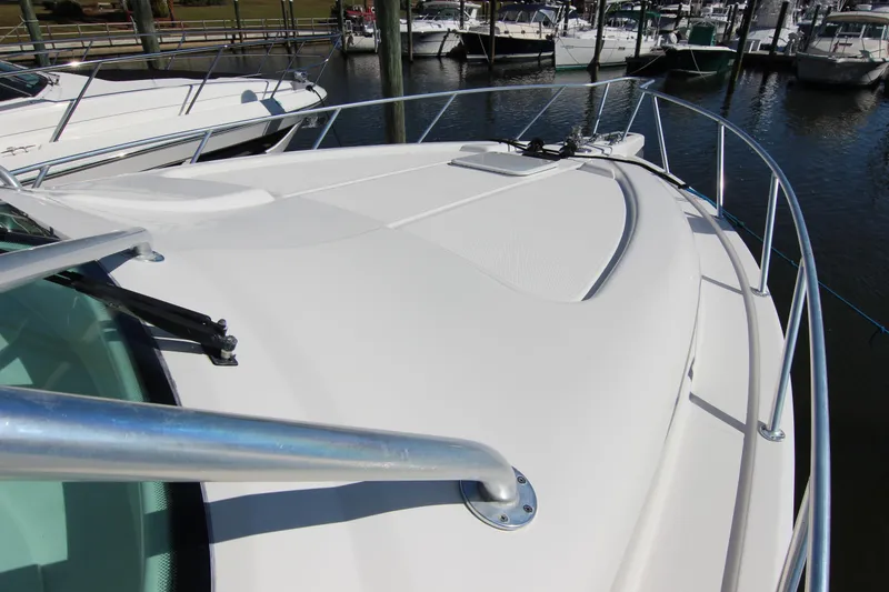 Slide: The Image of 2008 Bertram 360 yacht deck view at marina, showcasing sleek design and railing. - 7