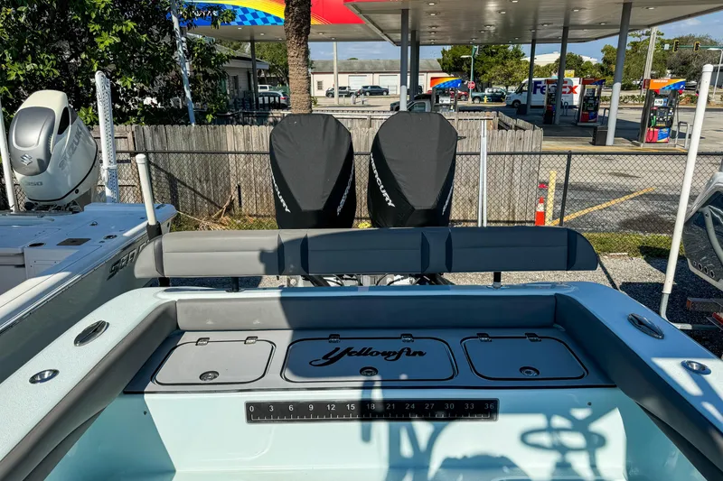 Slide: The Image of 2019 Yellowfin 26 Hybrid boat at a gas station, featuring dual engines. - 10