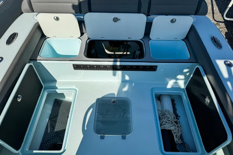 Slide: The Image of 2019 Yellowfin 26 Hybrid boat storage compartments and seating area. - 11