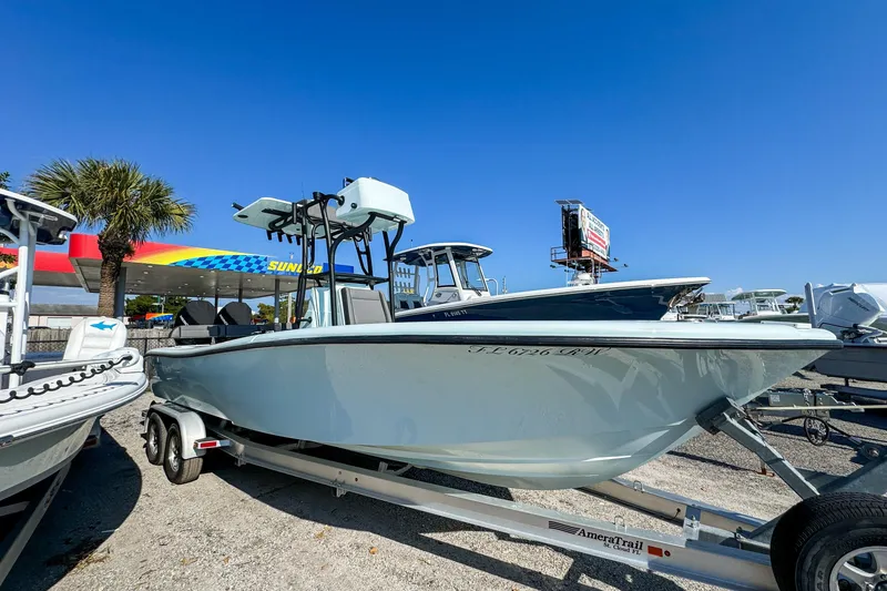 Slide: The Image of 2019 Yellowfin 26 Hybrid boat on trailer, parked near Sunoco station. - 14