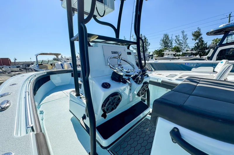 Slide: The Image of 2019 Yellowfin 26 Hybrid boat interior with steering console and seating area. - 15