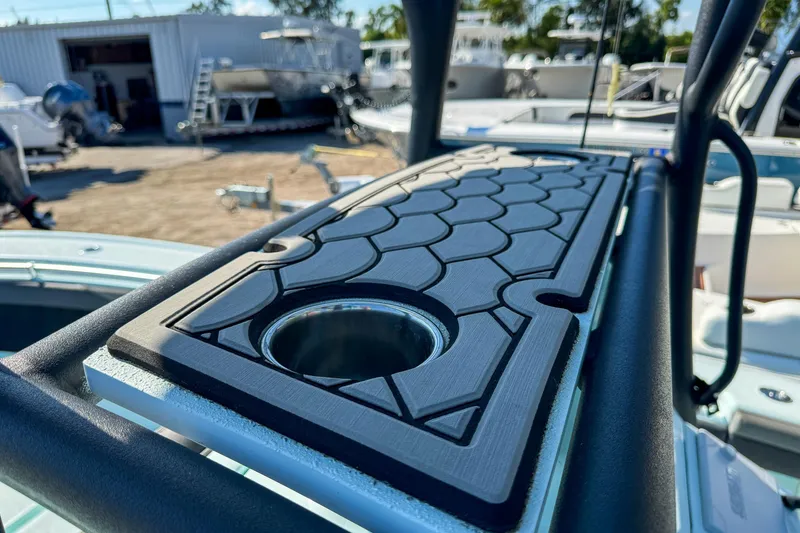 Slide: The Image of 2019 Yellowfin 26 Hybrid boat with detailed deck design in a marina setting. - 22