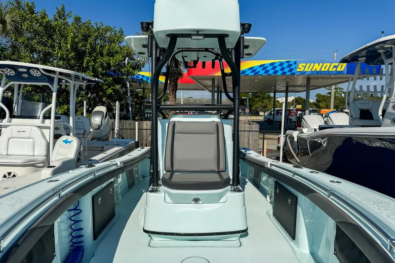 Slide: The Image of 2019 Yellowfin 26 Hybrid boat at a marina with Sunoco station in background. - 26
