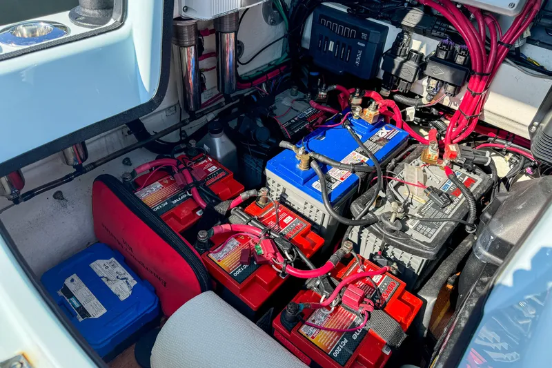 Slide: The Image of Engine compartment of a 2019 Yellowfin 26 Hybrid boat with multiple batteries and wiring. - 29