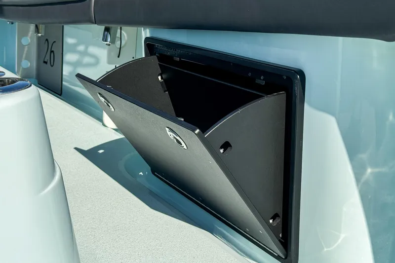 Slide: The Image of 2019 Yellowfin 26 Hybrid boat storage compartment open on deck. - 31