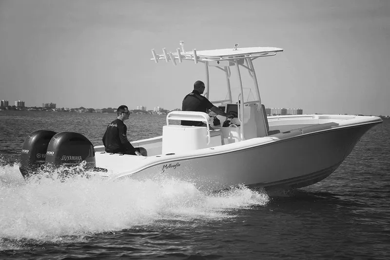Slide: The Image of Manufacturer Provided Image: 2019 Yellowfin 26 Hybrid boat cruising on water with two people onboard. - 36
