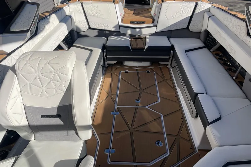 Slide: The Image of Luxurious interior of 2025 Nautique Super Air Nautique G25 Paragon boat, featuring elegant seating and flooring. - 12