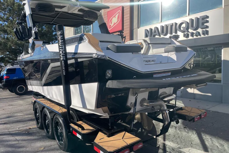 Slide: The Image of 2025 Nautique Super Air Nautique G25 Paragon boat on trailer at dealership. - 3