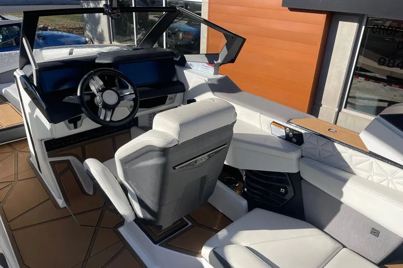Slide: The Image of 2025 Nautique Super Air Nautique G25 Paragon interior with modern steering and seating. - 6