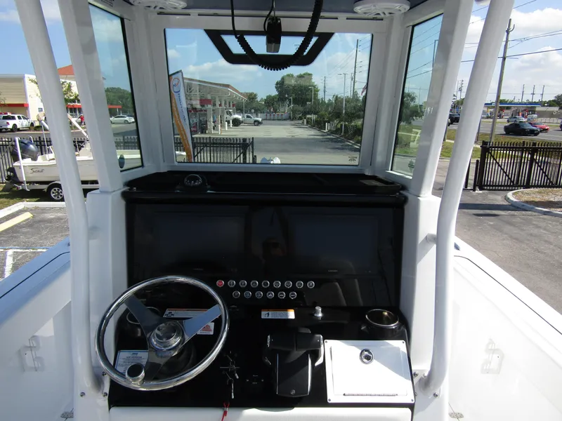 Slide: The Image of 2024 Wellcraft 263 Fisherman boat helm with steering wheel and control panel. - 15