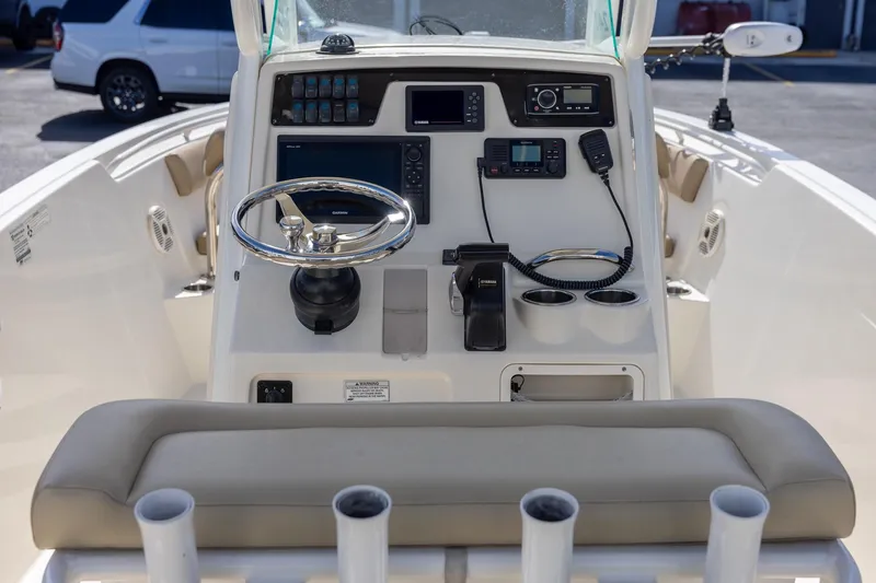 Slide: The Image of 2018 Sailfish 241 CC boat console with steering wheel and navigation equipment. - 12