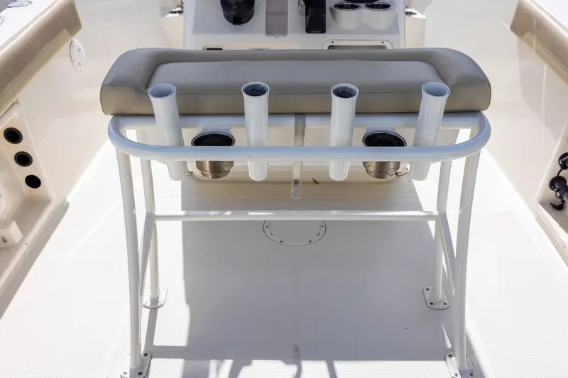Slide: The Image of 2018 Sailfish 241 CC boat interior with rod holders and cushioned seating. - 13
