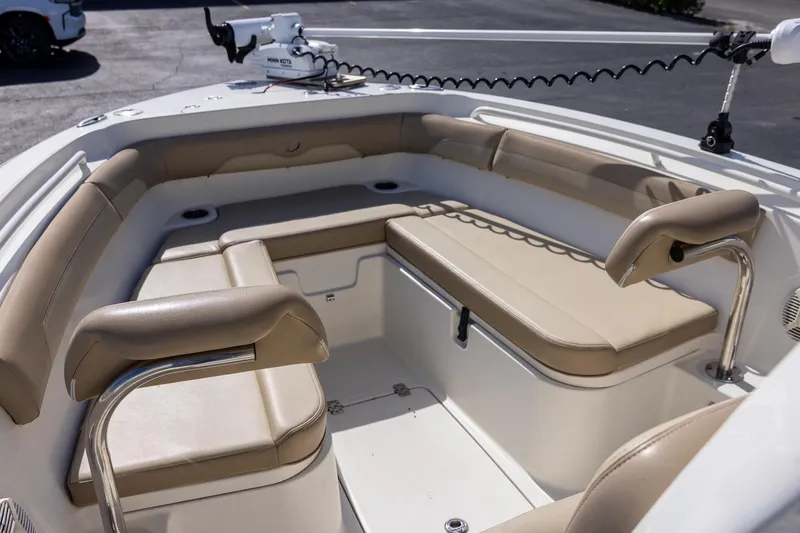 Slide: The Image of 2018 Sailfish 241 CC boat interior with beige cushioned seating and modern design. - 15
