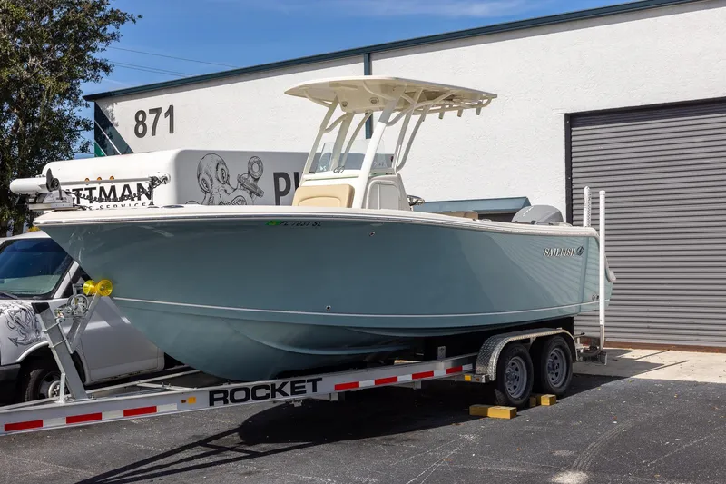 Slide: The Image of 2018 Sailfish 241 CC boat on trailer outside a building, ready for transport. - 2