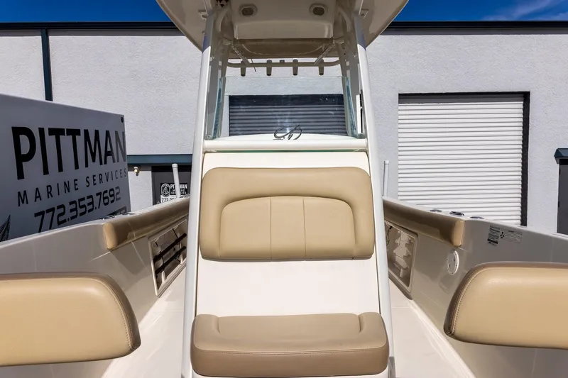 Slide: The Image of 2018 Sailfish 241 CC boat interior with beige seating, Pittman Marine Services sign. - 22