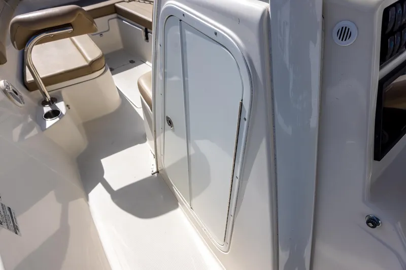 Slide: The Image of 2018 Sailfish 241 CC boat interior with seating and storage compartment. - 23