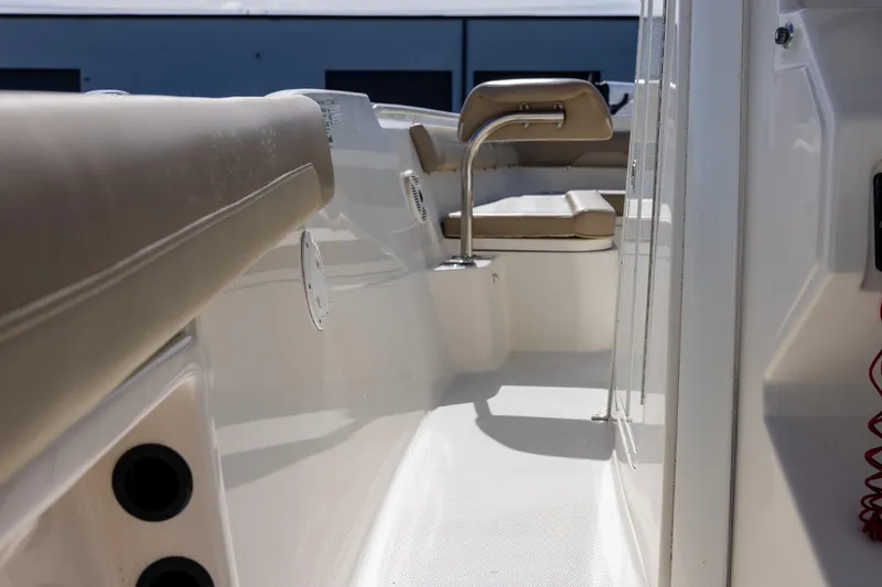 Slide: The Image of 2018 Sailfish 241 CC boat interior with beige seating and white deck. - 24