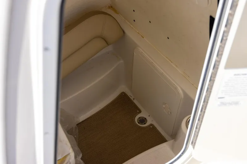 Slide: The Image of Interior view of 2018 Sailfish 241 CC boat cabin with beige seating and flooring. - 28