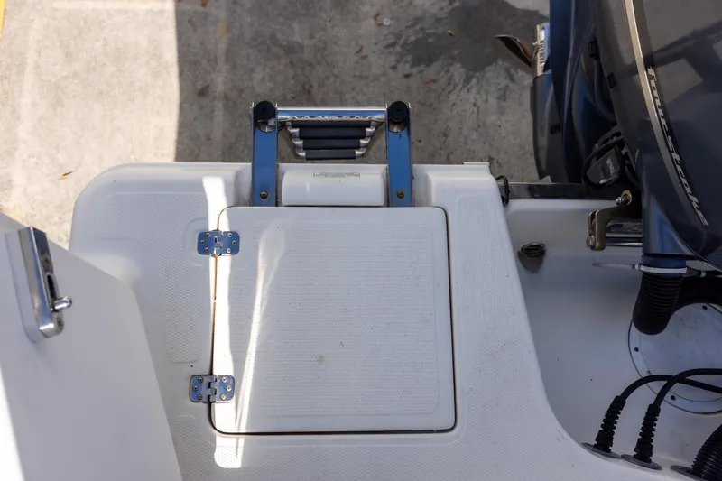 Slide: The Image of 2018 Sailfish 241 CC boat stern with ladder and engine detail. - 30