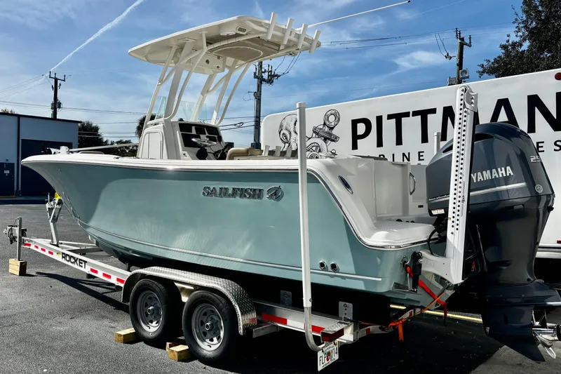Slide: The Image of 2018 Sailfish 241 CC boat on trailer with Yamaha engine, parked outdoors. - 5