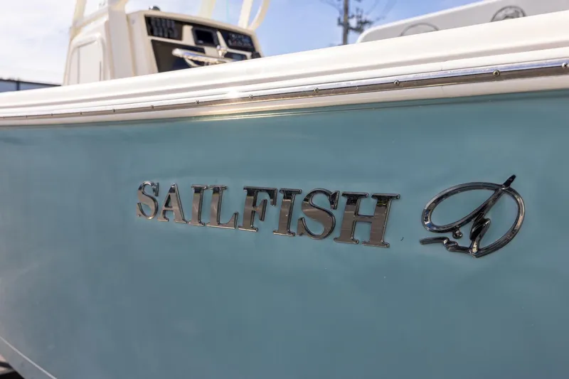Slide: The Image of 2018 Sailfish 241 CC boat with logo on light blue hull. - 9