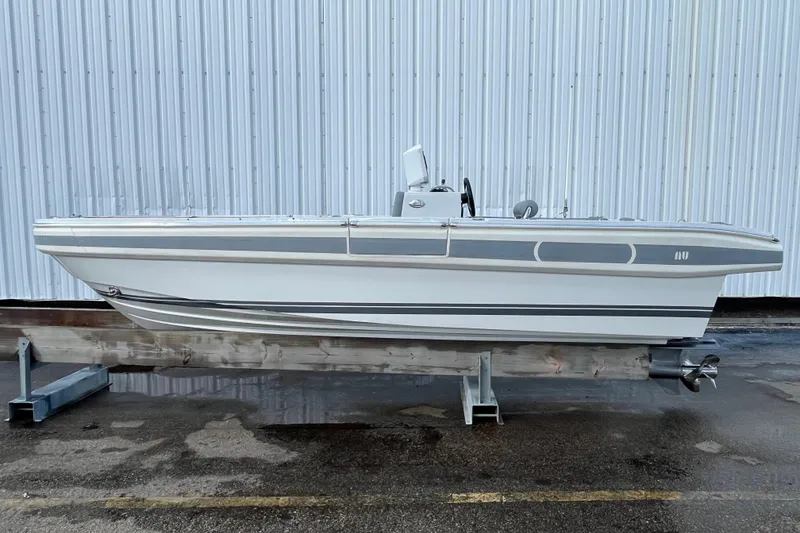 The Image of 2021 Novurania Chase 19 boat on display, side view against a corrugated metal wall. - 0