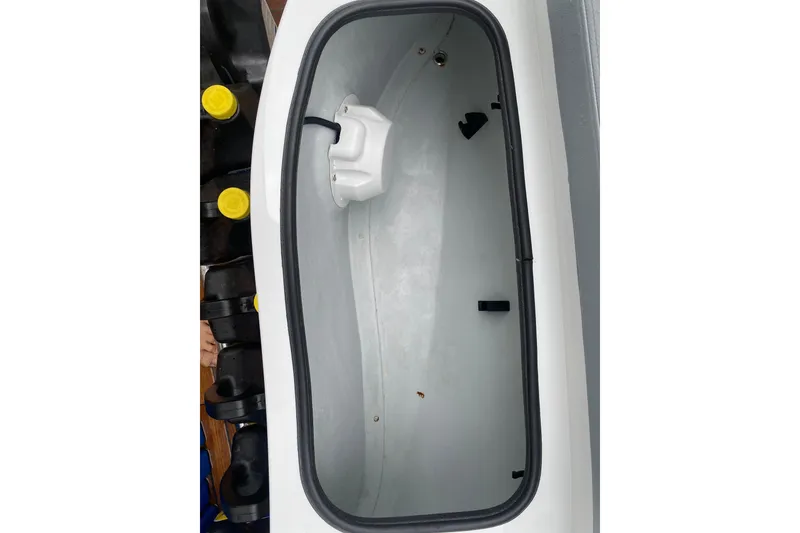 Slide: The Image of Open storage compartment of 2021 Novurania Chase 19 boat, featuring a clean interior. - 10