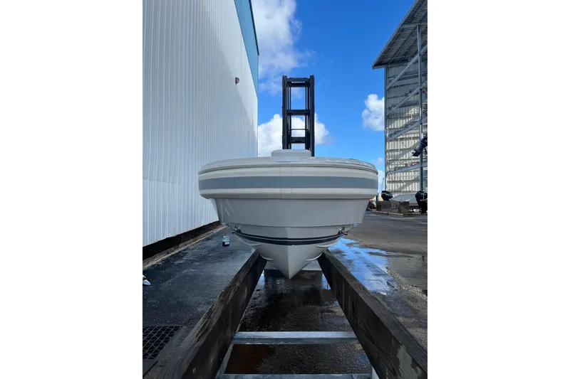 Slide: The Image of Novurania Chase 19 boat, 2021 model, docked outdoors under a clear blue sky. - 3