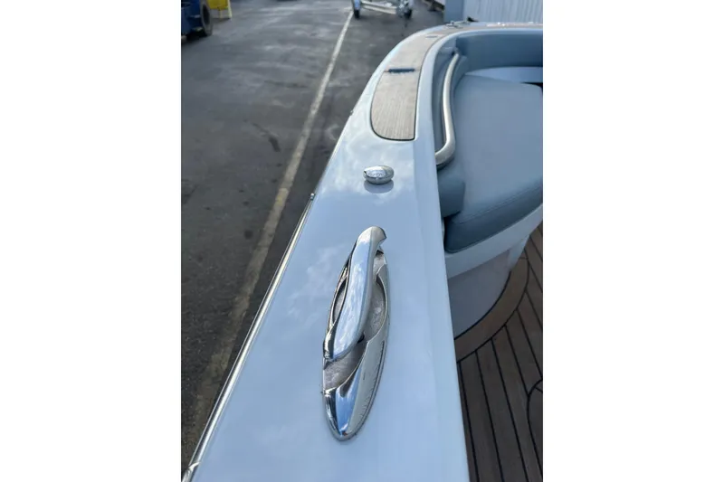 Slide: The Image of 2021 Novurania Chase 19 boat detail with chrome cleat and cushioned seating. - 8