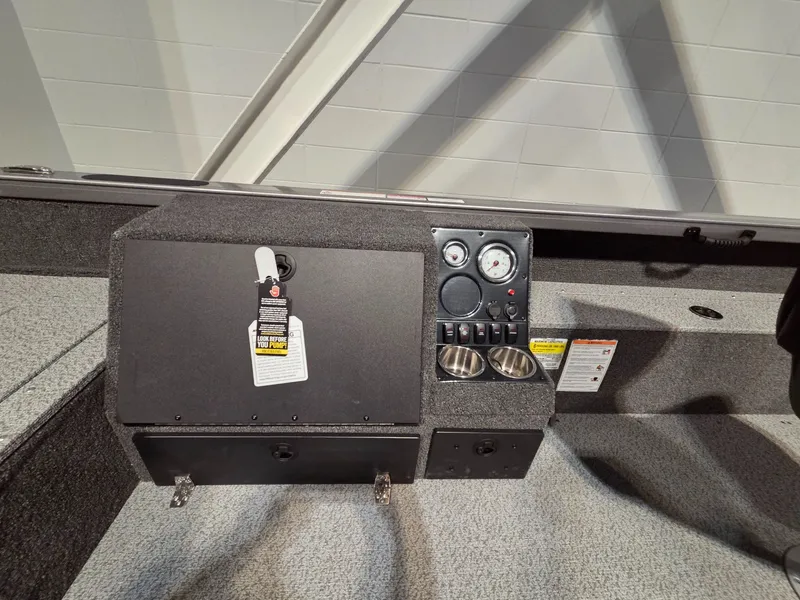 Slide: The Image of Dashboard of Crestliner 1850 Pro Tiller 2026 with gauges and cup holders. - 17