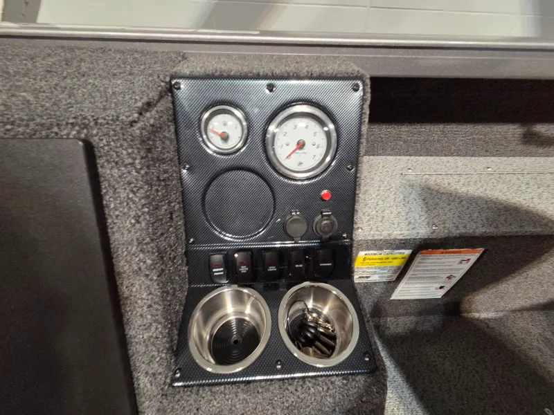 Slide: The Image of Dashboard of Crestliner 1850 Pro Tiller 2026 with gauges and switches. - 18