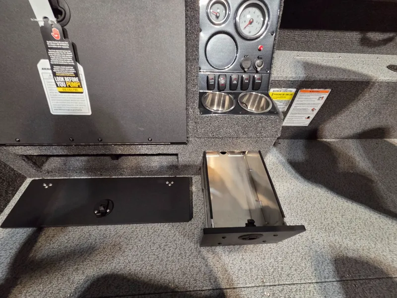 Slide: The Image of Interior view of 2026 Crestliner 1850 Pro Tiller with dashboard and storage compartment. - 21