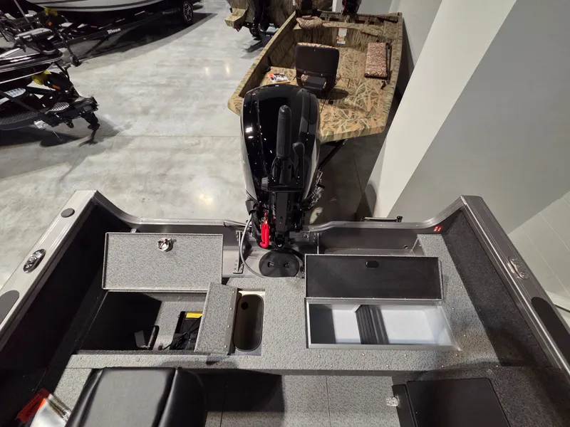 Slide: The Image of Interior view of 2026 Crestliner 1850 Pro Tiller with storage and motor. - 23