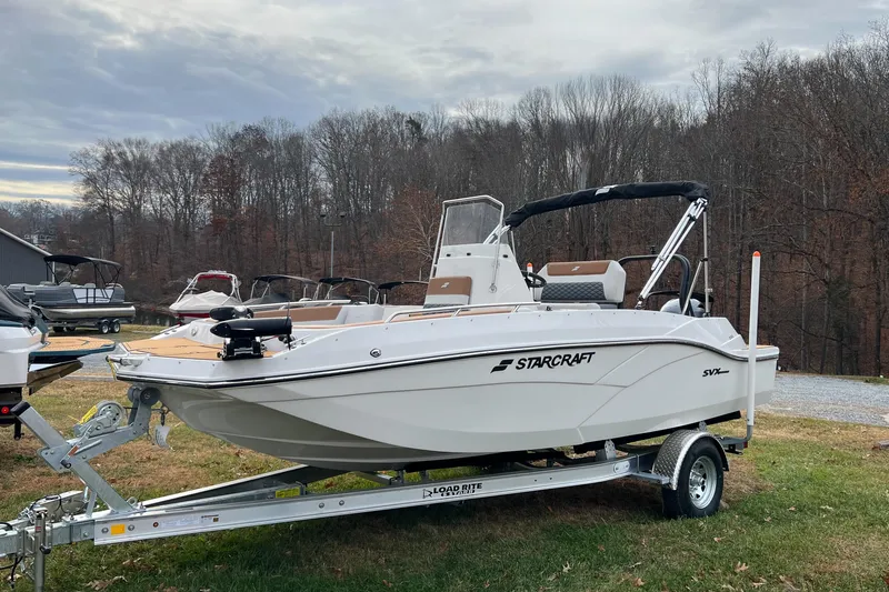 The Image of 2026 Starcraft SVX 191 OB CC boat on trailer, parked outdoors. - 1