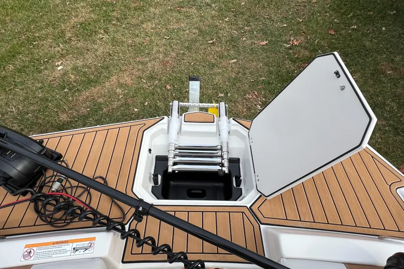 Slide: The Image of 2026 Starcraft SVX 191 OB CC boat with open hatch and ladder on deck. - 16