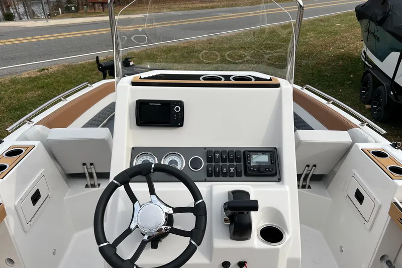 Slide: The Image of 2026 Starcraft SVX 191 OB CC boat dashboard with steering wheel and control panel. - 5