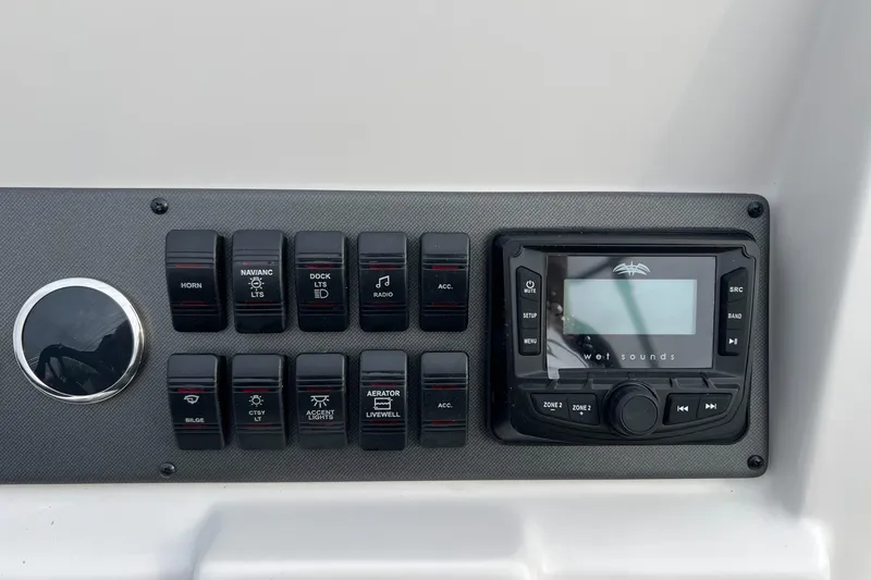 Slide: The Image of Control panel of 2026 Starcraft SVX 191 OB CC boat with switches and audio system. - 7