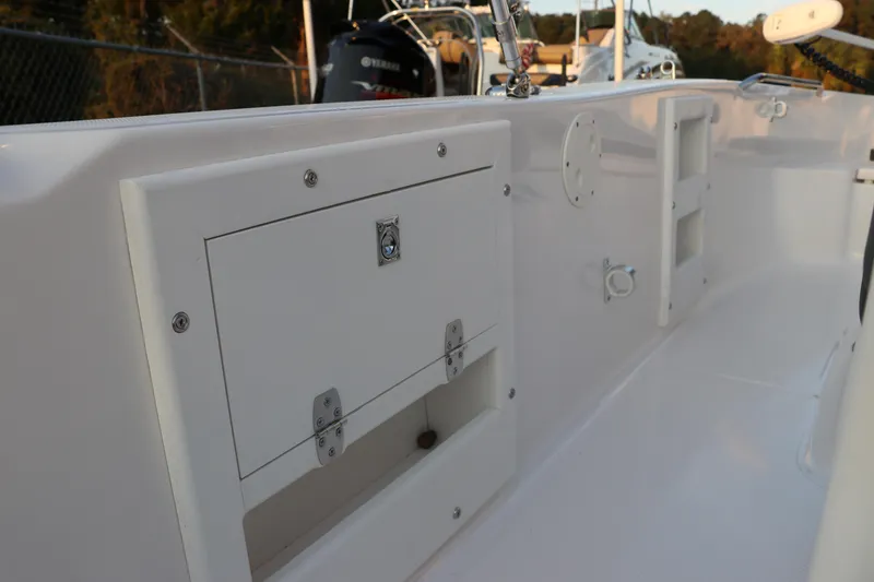 Slide: The Image of 2025 Robalo R160 Center Console boat interior with storage compartments. - 20
