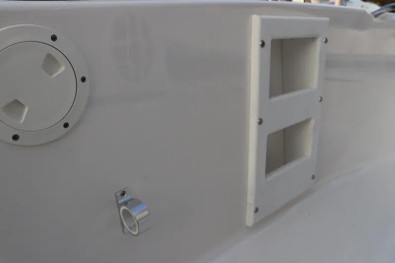 Slide: The Image of 2025 Robalo R160 Center Console boat detail showing deck fittings and storage compartments. - 22