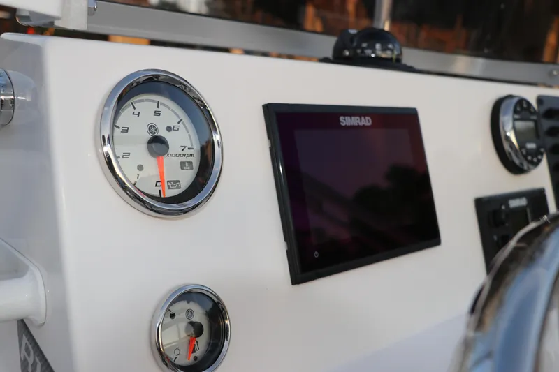 Slide: The Image of 2025 Robalo R160 Center Console dashboard with Simrad display and gauges. - 27